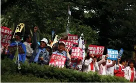  ?? (Thomas Peter/Reuters) ?? PEOPLE RALLY during a protest denouncing the policies of Japanese Prime Minister Shinzo Abe in Tokyo yesterday. The placards read: ‘Citizen change politics.’