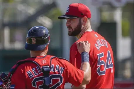  ?? GERALD HERBERT — THE ASSOCIATED PRESS ?? Red Sox pitcher Lucas Giolito and catcher Tyler Heineman walk together during a spring training workout. The pair are wearing MLB’s new uniforms, which have drawn heavy criticism from around the sport since their introducti­on.