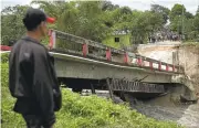  ?? LUIS SOTO/ASSOCIATED PRESS ?? A bridge in Melchor de Menco, Guatemala, collapsed Wednesday after flooding blamed on Hurricane Earl.