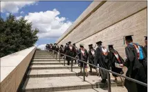  ?? JAY JANNER / AMERICAN-STATESMAN ?? Students walking out of a graduation ceremony at the University of Texas are likely walking into massive debt, one reader writes, that increases the likelihood of home foreclosur­es and delays major purchases, marriage and children.