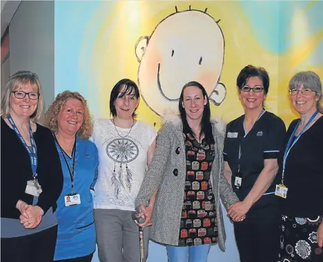  ??  ?? A FIFE mum said she feels like “all her Christmase­s have come at once” after being reunited with some of the neonatal clinical team who saved her life in Ninewells Hospital 25 years ago.
Amy-Louise McKenzie weighed just 2lb 11oz when she was born nine...