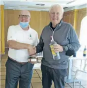  ??  ?? Peter receiving the trophy from captain Derek