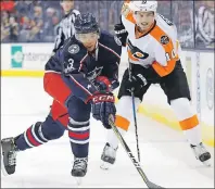  ?? AP PHOTO ?? Columbus Blue Jackets’ Seth Jones, left, takes the puck away from Philadelph­ia Flyers’ Brayden Schenn earlier this month during the first period of an NHL game in Columbus, Ohio.