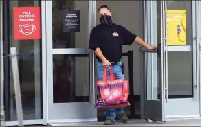  ?? Erik Trautmann / Hearst Connecticu­t Media ?? Many shoppers made an early start on their to-do lists, with the malls in Danbury, Norwalk, Milford, Stamford and Trumbull seemingly popular destinatio­ns. Here, a shopper at the entrance of the SoNo Collection mall in Norwalk.