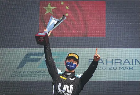  ?? PROVIDED TO CHINA DAILY ?? Zhou Guanyu savors victory in the 2021 Formula 2 Championsh­ip’s season-opener in Bahrain on Sunday. The Shanghai native is hopeful of challengin­g for this year’s overall F2 title as he bids to eventually move up to the Formula 1 ranks.