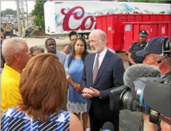  ?? KEVIN TUSTIN — DIGITAL FIRST MEDIA ?? Gov. Tom Wolf meets with local leaders before a tour of flood damage in Darby Borough.