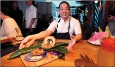  ??  ?? Trailblaze­r Tavern chef Wade Ueoka’s menu includes a porchetta lau lau wrapped in banana leaves.