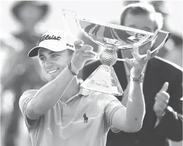  ?? Curtis Compton/Atlanta Journal-Constituti­on via AP, File ?? ■ Justin Thomas holds the trophy after winning the Fedex Cup after the Tour Championsh­ip golf tournament on Sept. 24, 2017, at East Lake Golf Club in Atlanta. The bonus pool for the PGA Tour season doubles next year to $70 million in a revamped system that pays $15 million to the FedEx Cup champion.