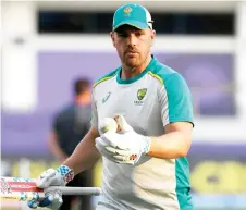  ?? — AFP photo ?? Finch warms up before the start of the Twenty20 World Cup cricket match between Australia and Sri Lanka in this Oct 28 file photo.