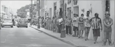  ??  ?? Los contagios de Covid-19 en Valladolid no cesan, lo que atribuyen muchos a la movilidad. En la foto, fila de jóvenes para cobrar una beca