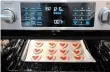  ??  ?? Stained glass cookies baking in the oven. The crushed candy in the centre melts in the heat.