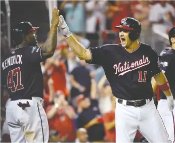  ?? WILL NEWTON / GETTY IMAGES ?? Ryan Zimmerman of the Washington Nationals celebrates with teammate Howie Kendrick after slugging a three-run homer in the fifth inning of Game 4 in their NLDS matchup with the L.A. Dodgers.