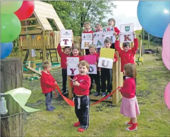  ??  ?? The youngsters declare their new play park open.