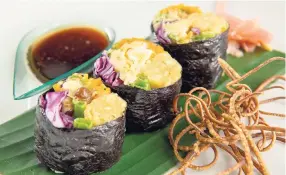  ??  ?? It's sushi time! Roll your palate around this vegan sushi with smoked breadfruit and curried ackee vegetable roll, served with a sesame soy sauce.