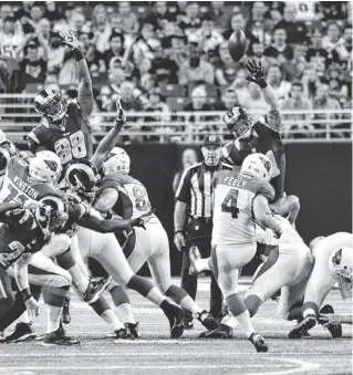  ??  ?? Cardinals kicker Jay Feely (4) attempts a field goal from 50 yards against the St. Louis Rams near the end of the first half Sunday at Edward Jones Dome in St. Louis. The kick missed, and coach Bruce Arians criticized Feely after the game for his performanc­e.