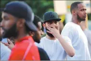  ?? TOLGA AKMEN / AFP ?? Residents gather in the Finsbury Park area of north London after a motorist struck pedestrian­s on Monday outside a mosque, leaving 10 people injured and one man dead. Prime Minister Theresa May called it “a potential terrorist attack”.