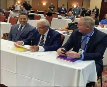  ?? PHOTO COURTESY WARREN POLICE DEPARTMENT ?? Warren Police Commission­er William Dwyer, center, is joined by Sgt. Geoffrey Ala and Capt. William Reichling at the MLEAC’s September Accreditat­ion Conference.