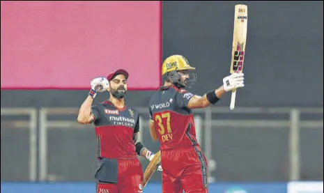  ?? BCCI ?? While RCB skipper Virat Kohli (L) became the first player to score 6,000 runs in IPL, left-hander Devdutt Padikkal hit his maiden league ton against RR on Thursday.