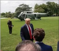  ?? The Associated Press ?? SOUTH LAWN: President Donald Trump speaks guests on the South Lawn before boarding Marine One on Thursday at the White House in Washington for a short trip to Andrews Air Force Base, Md., and then on to Cleveland, Ohio.