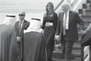  ?? AP Photo/Evan Vucci ?? U.S. President Donald Trump, accompanie­d by first lady Melania Trump, smiles at Saudi King Salman, left, upon his arrival at a welcome ceremony Saturday at the Royal Terminal of King Khalid Internatio­nal Airport in Riyadh, Saudi Arabia. Trump opened...