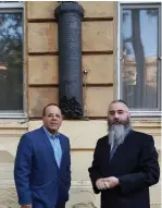  ?? (Courtesy) ?? COMMUNICAT­IONS MINISTER Ayoub Kara (left) and Rabbi Avraham Wolff stand next to a mezuza-shaped plaque at the former home of Ze’ev Jabotinsky in Odessa, Ukraine, last week.