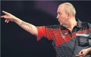  ??  ?? In last night’s final match, 15-time champion Phil Taylor powered his way into the semi-finals with a 5-3 victory over Scot Gary Anderson.