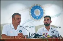  ??  ?? India captain Virat Kohli speaks as head coach Ravi Shastri looks on during a news conference at the Board of Control for Cricket in India (BCCI) headquarte­rs in Mumbai on Tuesday.