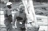  ?? AP/GERALD HERBERT ?? Workers wore masks, helmets and bullet-resistant vests as they removed the Robert E. Lee statue in New Orleans. Hundreds of people turned out to watch.