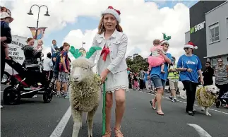  ?? PHOTO: WARWICK SMITH/FAIRFAX NZ ?? Inora Matson, 9, walks her Christmas lamb at a previous Feilding Christmas parade.