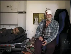  ?? AP PHOTO/FELIPE DANA ?? Injured civilians sit in an ambulance before being taken to a hospital after a Russian attack in Kharkiv, Ukraine, Saturday, April 16, 2022.