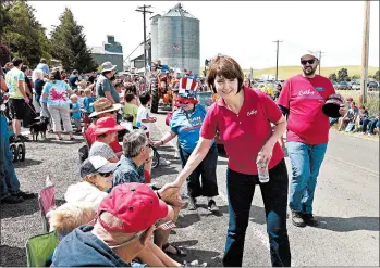  ?? TED S. WARREN/AP ?? Cathy McMorris Rodgers, R-Wash., shakes hands as she walks in the Fourth of July Parade in Johnson, Wash.