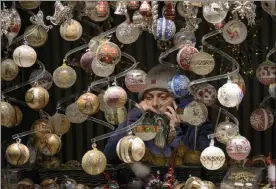  ?? Vadim Ghirda / ap ?? a vendor speaks on the phone at a christmas market in vienna, austria, on saturday.