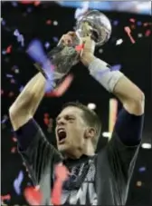  ??  ?? New England Patriots’ Tom Brady hoists the Vince Lombardi Trophy after the NFL Super Bowl 51 football game against the Atlanta Falcons, Feb. 5 in Houston.