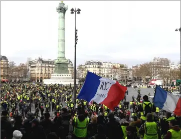  ??  ?? People gather in place de la Bastille, in Paris during anti-government demonstrat­ion called by the Yellow Vest ‘Gilets Jaunes’ movement.