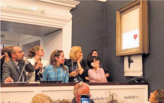  ?? Photo / Banksy, Instagram ?? Confusion and shock in the room at Sotheby’s as Banksy’s painting drops down in its frame, shredding itself.