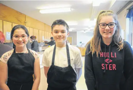  ?? ANDREW ROBINSON/THE TELEGRAM ?? Grade 7 Brother Rice Junior High students (from left) Sofia Alberto, Landen Lee and Brooklyn Fahey are happy to help fellow youth by preparing meals for Thrive in St. John’s.