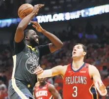  ?? Gerald Herbert / Associated Press ?? Warriors forward Draymond Green loses the ball as he drives to the basket against New Orleans forward Nikola Mirotic.