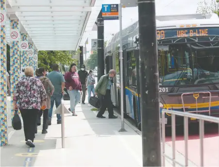  ?? MIKE BELL ?? Transit riders board a bus on Broadway near Commercial Drive on Monday. Ridership patterns have already changed.