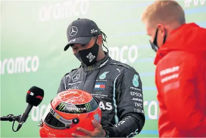  ?? AP ?? El legado. Lewis Hamilton recibe el casco de Schumacher que le regaló Mick, el hijo del alemán.