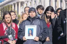  ?? SCOTT APPLEWHITE/ASSOCIATED PRESS ?? During a rally on Friday, Ilan Alhadeff, joined at left by his wife Lori Alhadeff, holds a photograph of their daughter, Alyssa, 14, who was killed at Marjory Stoneman Douglas High School in Parkland, Fla.