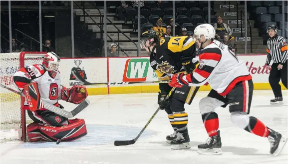  ??  ?? Ottawa 67’s goalie Olivier Tremblay stops Hamilton Bulldogs forward Will Bitten from in close Sunday as the 67’s edged the host Bulldogs 5-4 in Game 2 of their quarter-final series.