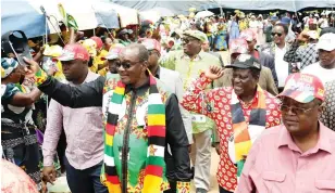  ?? - Picture Eliah Saushoma ?? Acting President Kembo Mohadi accompanie­d by ZANU PF national political commissar Cde Mike Bimha (second from right) and the party aspiring candidate for Pelandaba-Tshabalala constituen­cy Cde Joseph Tshuma greet supporters at a rally held in Nkulumane Bulawayo yesterday.