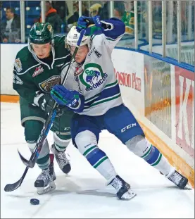  ?? STEVEN MAH/SOUTHWEST BOOSTER ?? Swift Current Broncos’ forward Ryley Lindgren (right) muscled Everett’s Wyatte Wylie off the puck during a 3-2 overtime loss Saturday.