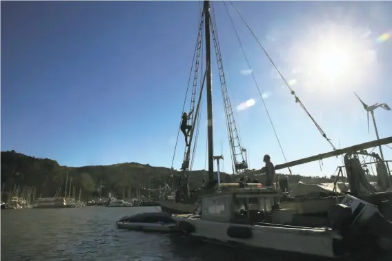  ?? Photos by Michael Macor / The Chronicle ?? Liberty Darling, 11, climbs the rigging of the CA Marcy, one of the anchor-out boats off Sausalito, where she has lived for seven years with godfather Greg Baker.