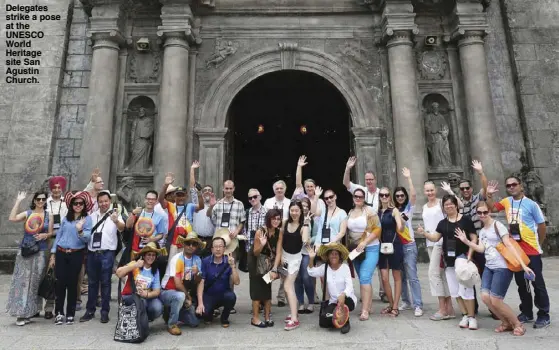  ??  ?? Delegates strike a pose at the UNESCO World Heritage site San Agustin Church.