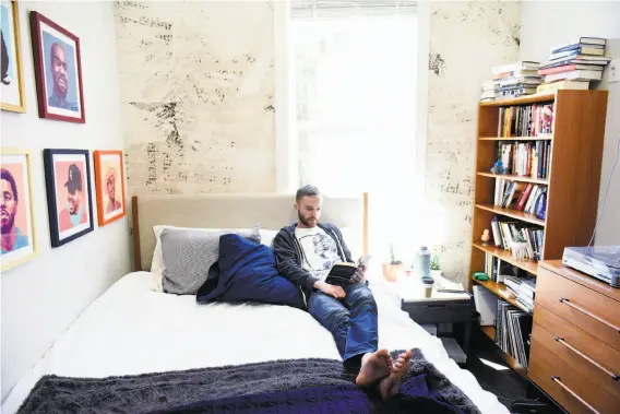  ?? Photos by Michael Short / Special to The Chronicle ?? Chris Maddox, the first resident to move into Starcity’s building in the Mission District, relaxes in his room. He says his place has a diversity his old one lacked.