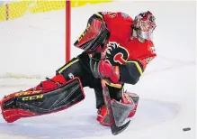  ??  ?? Flames goalie Mike Smith clears the puck en route to his shutout over Arizona in Calgary.