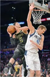  ?? AP ?? Josh Hart (left) of Los Angeles Lakers shoots as Dirk Nowitzki of Dallas Mavericks defends during their NBA basketball match on Friday. Lakers won 124-102. —