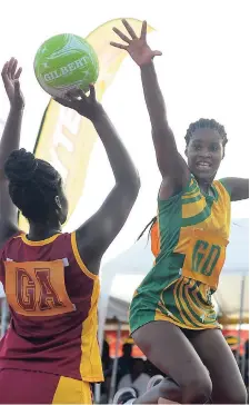  ?? SHORN HECTOR/PHOTOGRAPH­ER ?? Excelsior High’s Natassia Duncanson (right) jumps high to block an attempt by Holmwood’s Shoshagaye Forbes during yesterday’s Americas Federation of Netball Associatio­ns Champion of Champions High Schools Netball final at the Leila Robinson Courts.