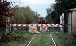  ?? HASSARD STACPOOLE ?? Staff from contractor McCormack Brothers have cleared the Limerick to Foynes Line in advance of reconstruc­tion using road railers. McCormack’s plant is seen at Ashford Level Crossing, between Limerick and Patrickswe­ll, on October 24. The line’s last movement before it was mothballed was in January 2003.